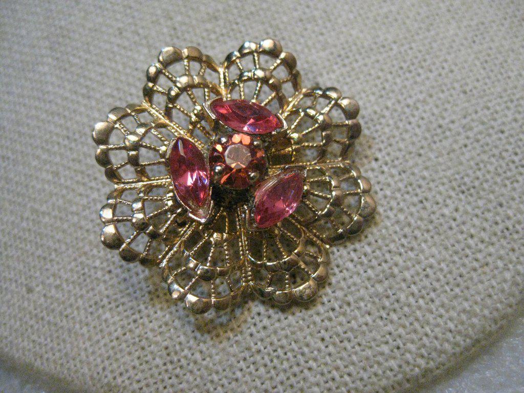 Vintage Filigree Pink Rhinestone Brooch, 1960's, 1.25",: Vintage Gold Tone Pink Rhinestone Brooch - 1.25" with a frilly filigree base and three pink marquis stones and a round center stone. Age is 1960's. It is not signed. This came from a PA estate. Very g