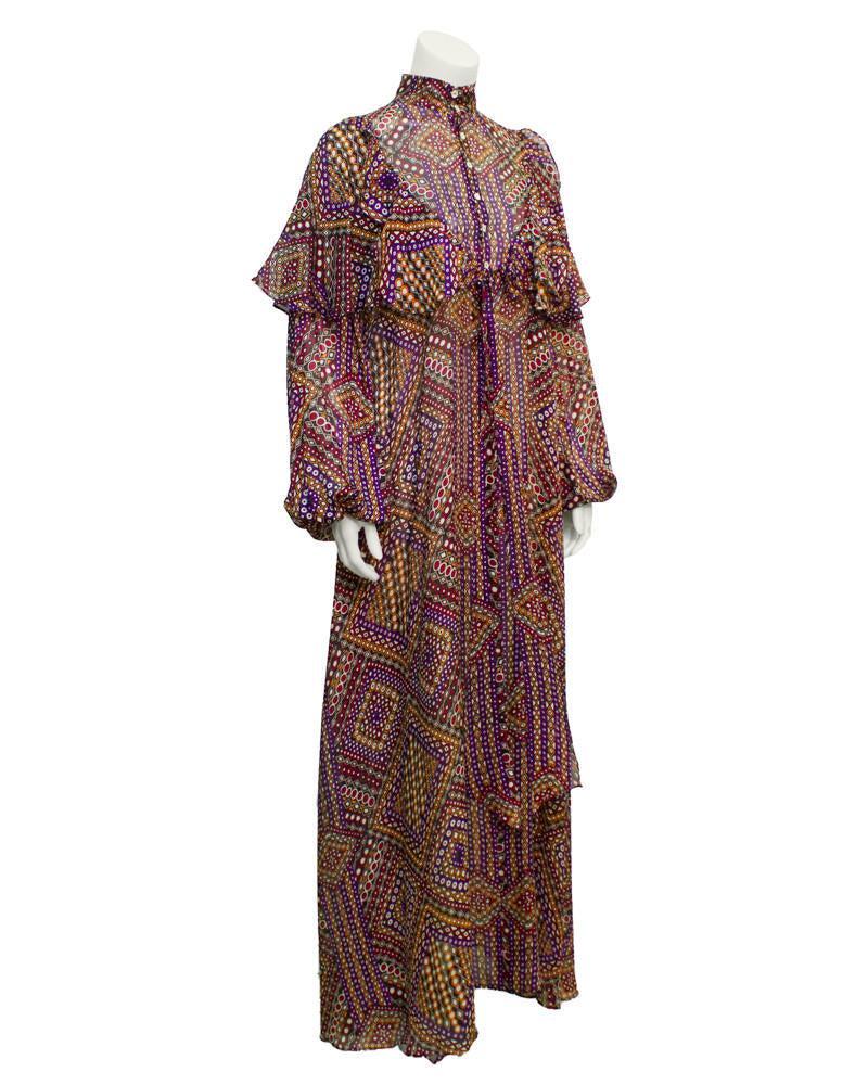 Annacat Purple Psychedelic Geo Print Maxi Dress: Enchanting late 1960s psychedelic chiffon geo print dress with a long, billowing and utterly romantic silhouette. Stand up collar with full balloon sleeves and gathered cuffs. Unique shawl like ruffle