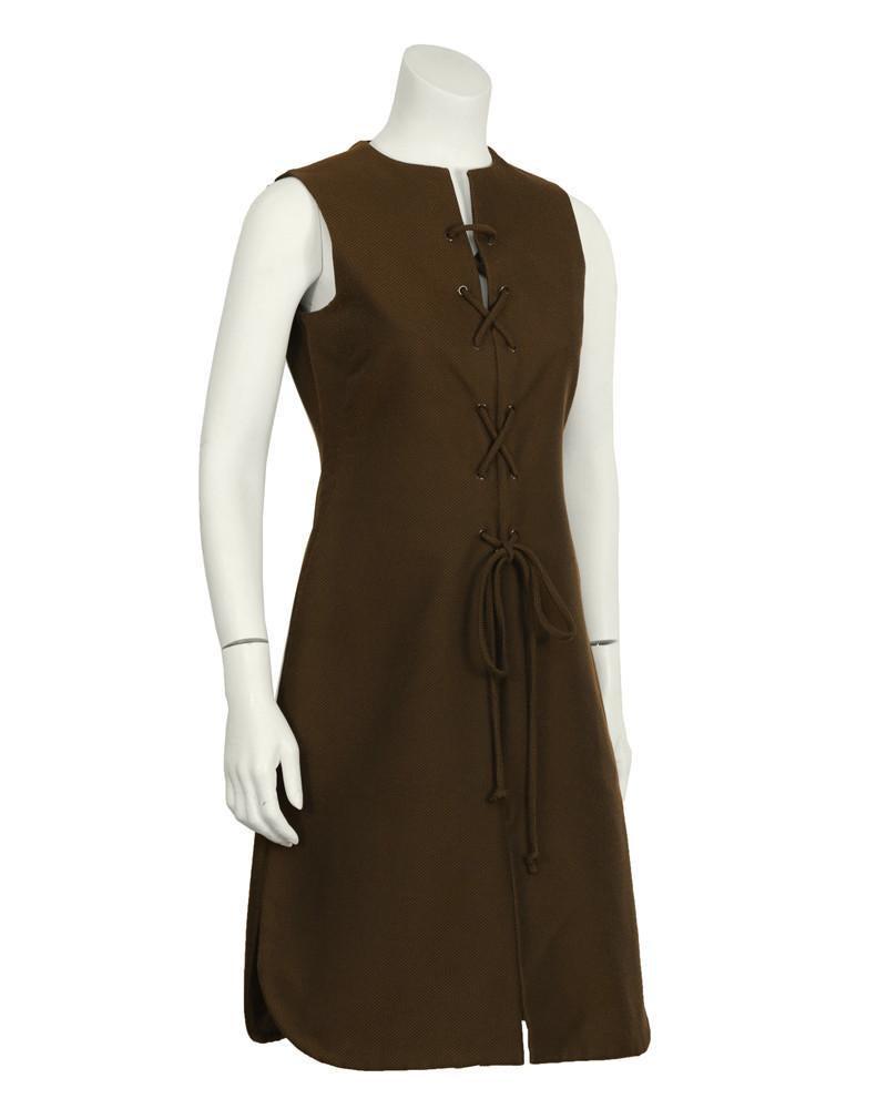 Geoffery Beene Brown Lace-up Dress: Early 1970’s Geoffrey Beene chocolate brown cotton pique lace front day dress. The sleeveless slit neck dress features brown metal grommets around the front that allow for easy lacing. Slit in the f