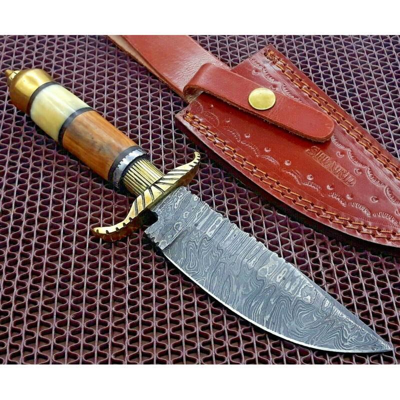 Damascus steel knife, camel bone knife, olive wood: Knife "Brassy" made of damask steel. Handle – camel bone & olive wood, brass, scabbard - leather. Damascus knives are very durable, look great and keep sharpness perfectly. Damascus steel has high q