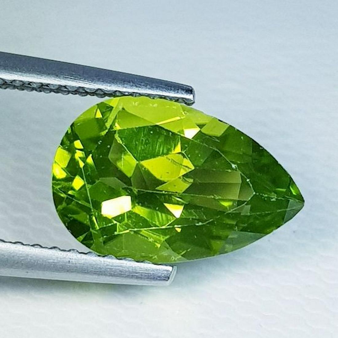 Natural Peridot Pear Cut 3.10 ct: No Reserve! Title: Natural Peridot Pear Cut 3.10 ct Color/Clarity: VVS Carat Weight: 3.1 Size/Dimensions: 11.90 x 7.80 x 5.10 Additional Information: Pear - Pakistan Shipping: Domestic: Flat-rate of