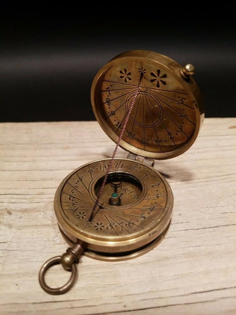Antique Brass Sundial Compass: 2" Nice antique reproduction sundial compass. To use on a sunny day you would face north and the shadow cast on the face of the compass will reveal the time. From what I understand you may need to com
