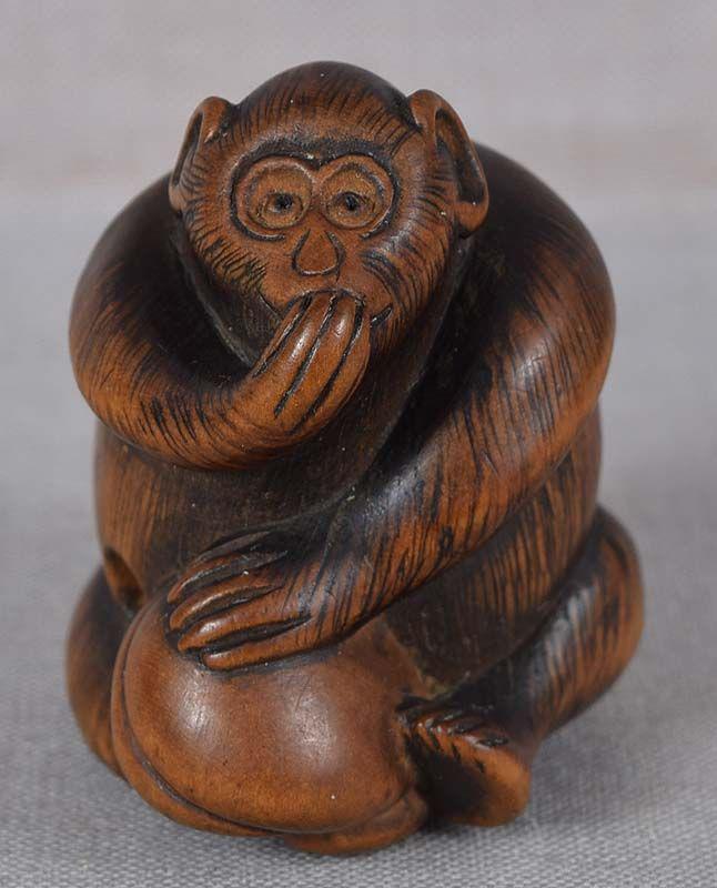19c netsuke MONKEY with peach from FHC collection of: 19th century wooden netsuke of a seated monkey, its hand raised to its mouth in amazement at the size of a peach that it holds with other limbs. Superbly caught facial expression, wonderful hairwork, 