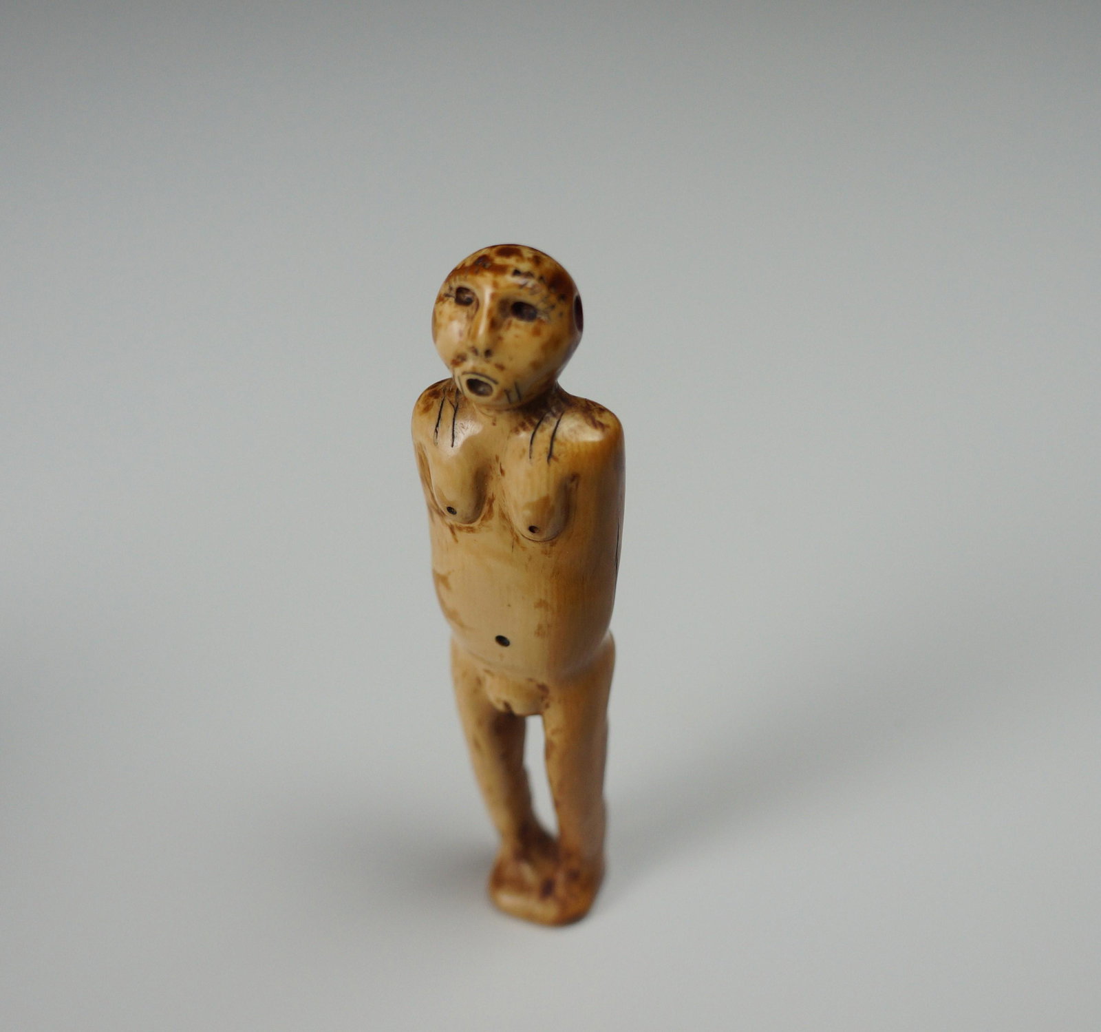 Antique INUIT Female Figure - Bering Strait: Title: Antique INUIT Female Figure - Bering Strait Date/Period: 4000 y/o+ material - early to mid 20th century carving Origin: Alaska Dimension: 3.5 inches tall - 23 grams Material: Tusk Description: 