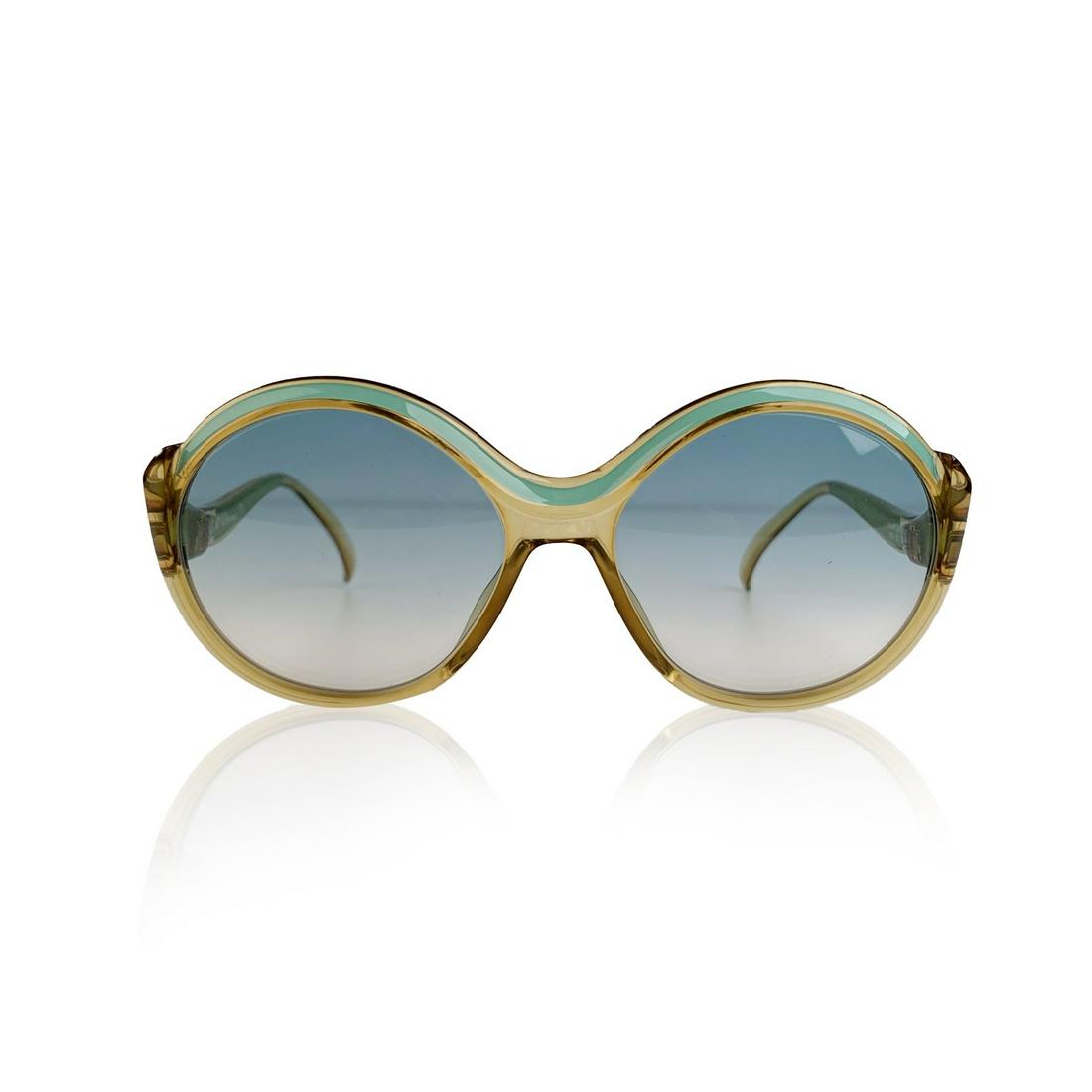 Christian Dior Vintage Green Round Optyl Sunglasses Mod: CHRISTIAN DIOR Vintage 1970s aqua green and translucent honey color frame. Turquoise gradient new lenses. Optyl frame handmade in Germany. CD logo on temples. Mod. & Refs: 2078 - 60 - 56/17. Details M