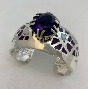 New Mexico Sunset - Osavio Crespin: Title: New Mexico SunsetArtist's Name: Osavio CrespinDate/Period: 2018Materials: Sterling Silver Braclet with sugalite; mother of pearl; Center stone - AmethystDimensions: 18x24Native American Tribe: