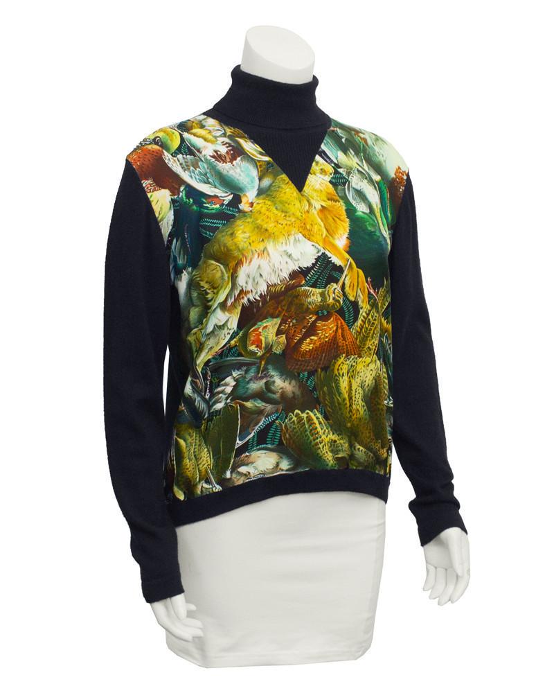 Hermes Black Cashmere Turtleneck with Silk scarf front: Classic 1970s Hermes black cashmere turtleneck sweater with silk 'scarf' front. The silk 'scarf' features a game bird motif in browns, deep greens and blues. Ribbing at neck and cuffs. In excellent co