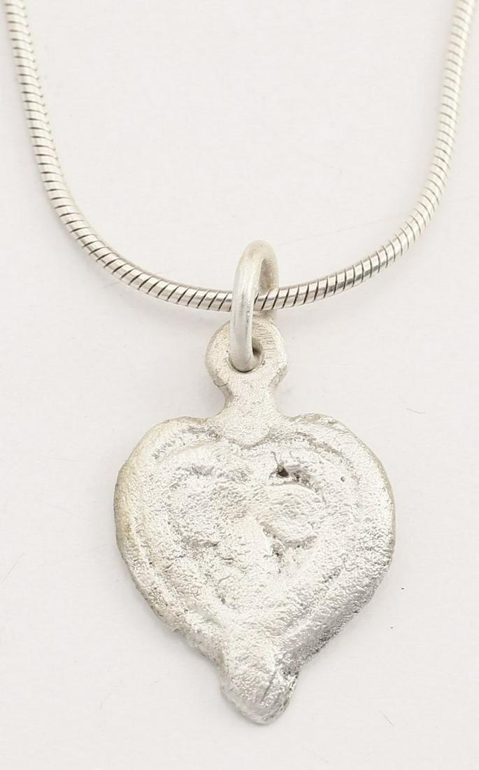 GOOD VIKING HEART PENDANT 9th-10th CENTURY AD.: Just under 3/4” height, of iconic form. Cusped top heart with raised rounded edge, a heart within a heart! The field with a trefoil, a popular Viking motif. For Vikings, the heart stood for bravery,