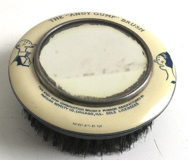 The “Andy Gump” Brush Combination Brush and Mirror: Title: The “Andy Gump” Brush Combination Brush and Mirror Dimensions: 3 1/2 x 1 1/4” Provenance/Additional Info: Shipping: Domestic: Flat-rate of $10.00 to anywhere within the contiguous U.S. In