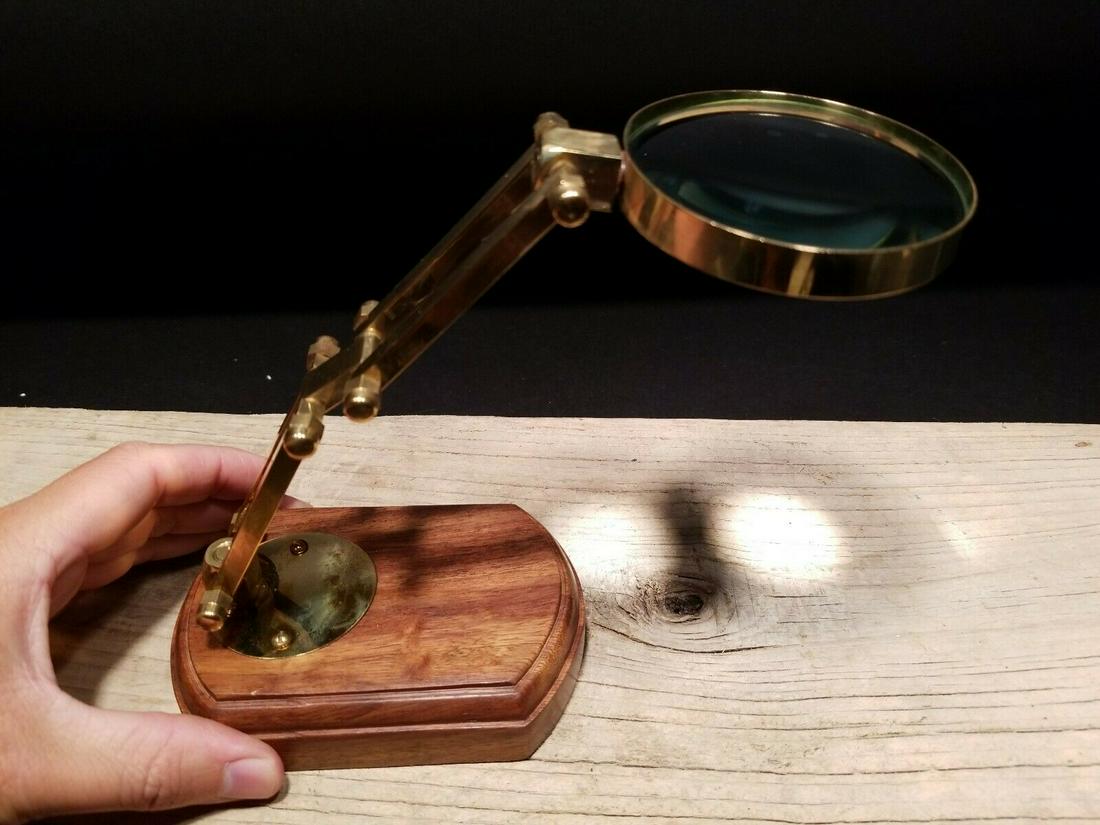 Adjustable Table top Arm Magnifying glass Desk: 12" Tall 9 5/8" long arm.. Nice reproduction of an antique! All solid brass and heavy marble looking base. The arm adjust is quite stiff. It will tip over if the adjustment is made too far off balance