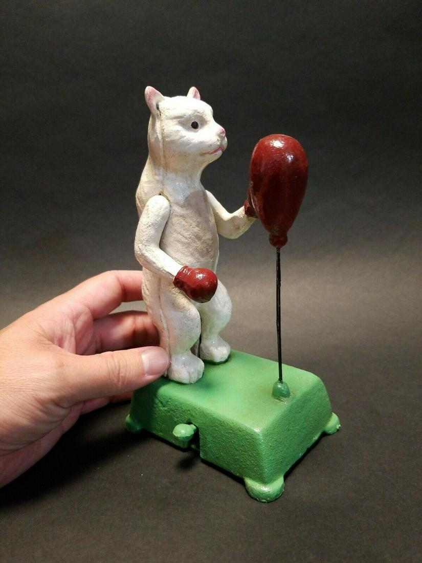 Cast Iron Boxing Cat Mechanical Toy: 6 1/4" Tall x 4 1/2" long x 3" Wide 3lbs 7oz A wonderful reproduction cast iron collectible boxing cat toy. All hand painted. This cast iron toy as you can see operates by pushing down the lever. It w
