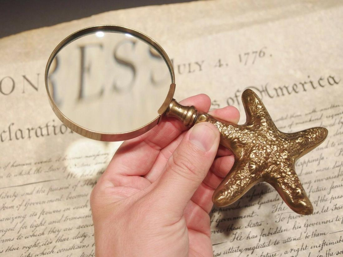 Brass Starfish Magnifying Glass Desk Hand Lens: 7" Long x 3" Wide glass Nice reproduction of an antique Magnifying glass with a cast brass starfish handle. Magnifying glasses like this were used in the 18th and 19th century due to the poor lighting