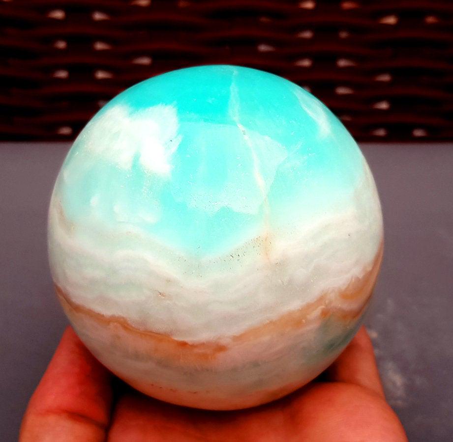Carribean Calcite Sphere Ball , Blue Calcite Gemstone: Materials Carribean calcite, calcite more Description This listing is for this exact Caribbean calcite aragonite ball. The color is more seafoam green and blue green and there are layers of sandy colo