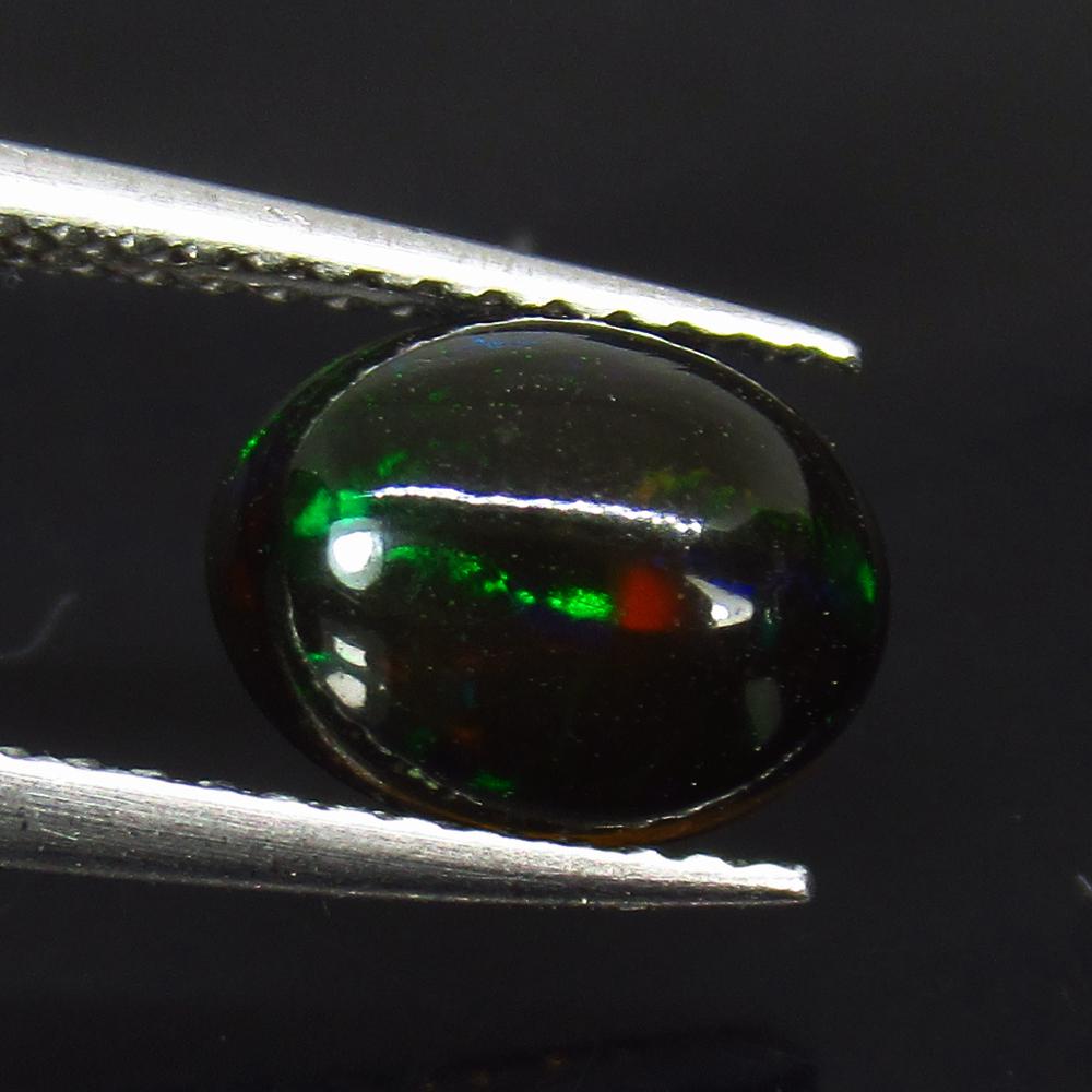 1.23 Ctw Natural Ethiopian Black Fire Opal Oval Cab: No Reserve! Title: 1.23 Ctw Natural Ethiopian Black Fire Opal Oval Cab Stone Clarity: Translucent Gemstones: Black Opal Carat Weights: 1.23 Size/Dimensions: 9.10 x 7.10 x 4.10 mm Additional Informatio