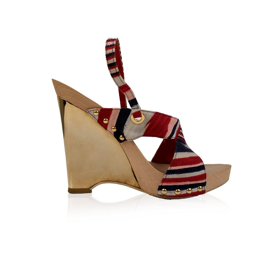 Missoni Multicolor Striped Fabric Golden Wedge Sandals: Missoni's wedges sandals. They feature a striped fabric upper a wood insole and gold tone wedges. Open toe. Slip on. Size is not indicated. Estimated size is a 38. Heels height: 5.25 inches - 13 cm. I
