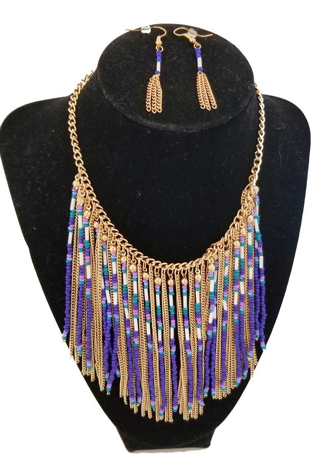 NWT Tassel Necklace Purple Gold Beaded and Pierced: Purple and Gold Beaded Tassel Necklace with pierced tassel earrings. Purple and Gold beaded tassels move effortlessly and fall delicately. Perfect on an open neckline or flat neckline. Measurements: 1