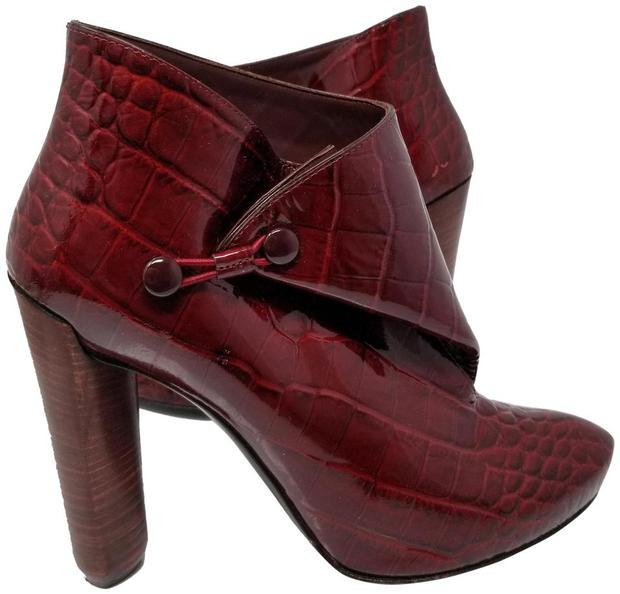 Louis Vuitton Vernis Leather Red Ankle Boots Booties: Louis Vuitton Vernis Leather Red Ankle Bootie Boots Size 39. We offer this pair of ankle boots from Louis Vuitton in a shiny maroon red leather with wooden heels. The stylish booties are crafted from