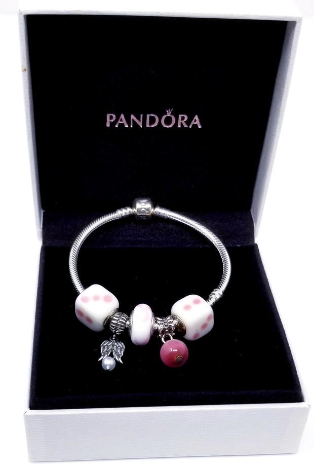 Pandora Charm Bracelet Dice Breast Cancer Pink White: Pandora Charm Bracelet with Charms of Dice, Breast Cancer and Angel Wings. This bracelet has a pink and white color theme showing off two dice at either end, (marked 925), separated by two smaller cha