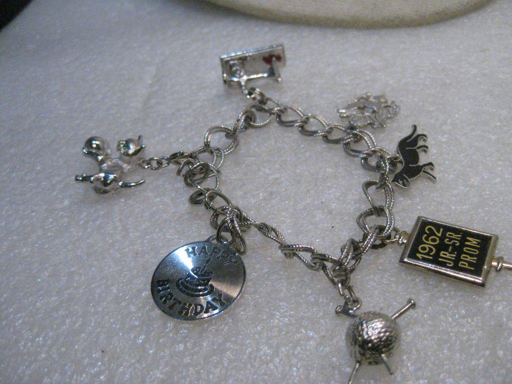 Sterling Silver 8.5mm Charm Bracelet, 1960's, 7", 34.01: Sterling Silver Charm Bracelet, 7", 1960's with 7 charms, 2 are sterling. Going in order of their alignment on the bracelet * 30D cat with ball, rhinestone eyes, not signed, silver tone; * 30D Old Tim