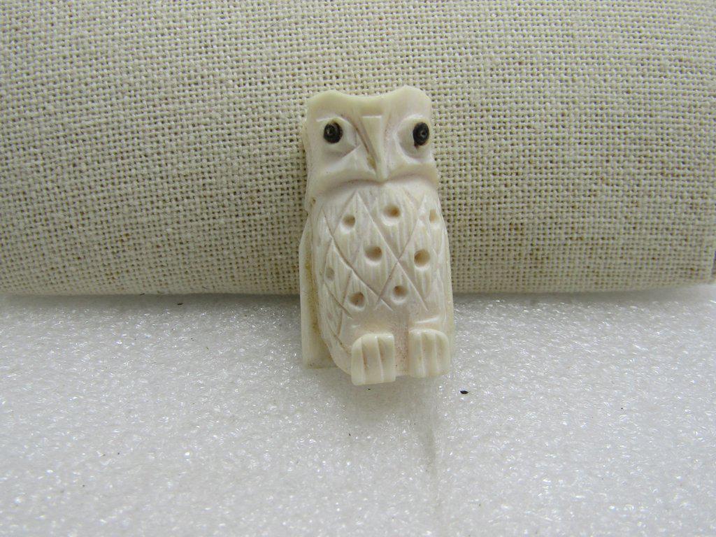 Carved White Owl Bead/Pendant, Black Eyes, Ox Bone,: Carved White Owl Bead or Pendant, Faux or carved bovine/Ox Bone, 1.5" tall and nearly 3/4" wide. Can stand up if placed on table. Rustic look but also more modern look than older carved pieces. It is 