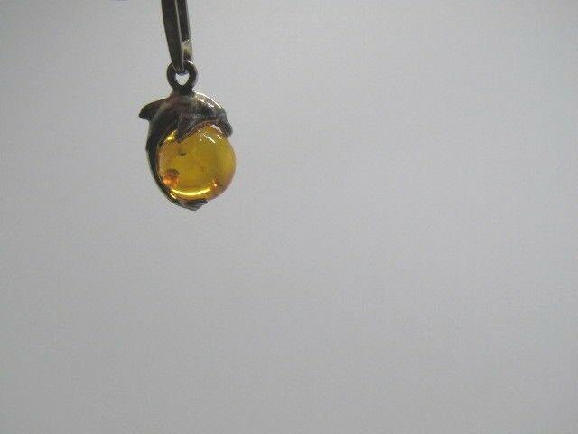 Sterling Silver Baltic Amber Dolphin Pendant, 7mm: Vintage sterling silver Baltic Amber Dolphin pendant - in it's original case with tags. Weight is .85 grams and it is appx. 3/4" long and the amber ball is about 7mm. Age is 1970's-1980's. The tags li