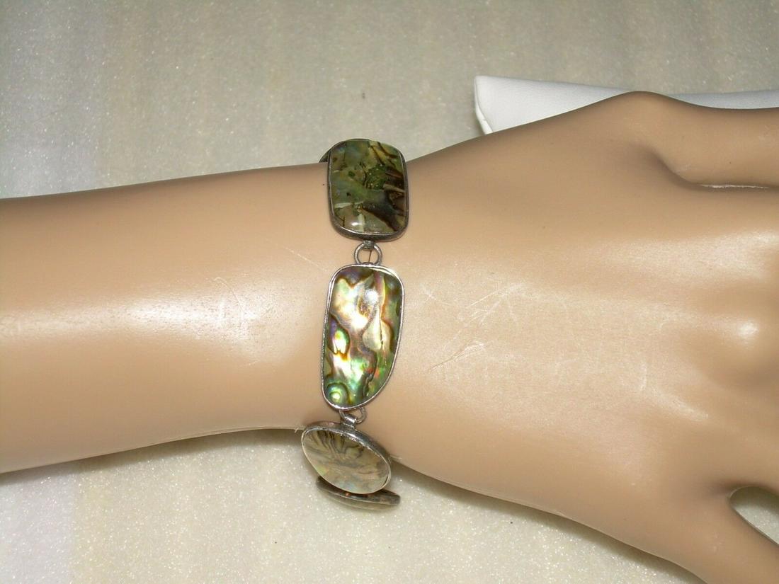Vintage Sterling Silver Abalone Bracelet - Marked 925 -: Vintage Abalone bracelet is from the 1980's. It is a link bracelet with a toggle clasp. Measuring 8" in length and marked 925 and LUG on the clasp. The weight of the bracelet is 12 grams. The bracelet
