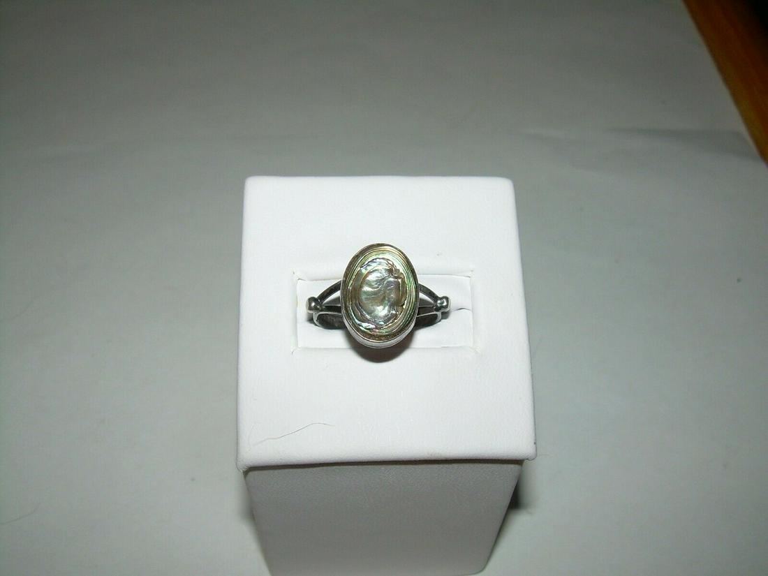 Sterling Split Band Abalone Ring, Marked Mexico, Signed: Vintage sterling silver split band abalone ring. The front of the band measures 4.1mm and tapers down to 2.4mm in the back. The stone is approximately 10.8mm x 7.8mm. The ston is bezel set. The ring i