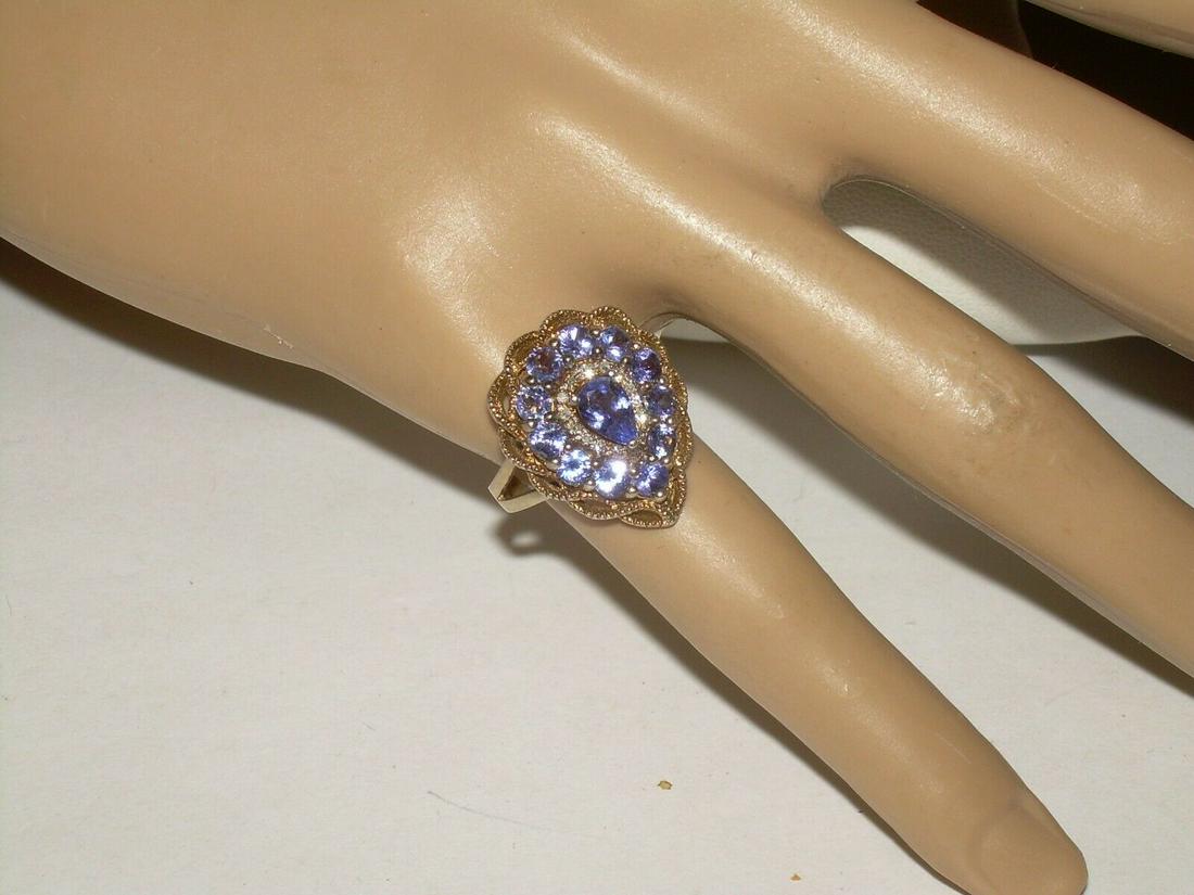 Sterling Filigree Tanzanite Ring, Signed Stauer, 925,: Vintage sterling silver is a cluster tanzanite and diamond aura cocktail ring. The ring has a filigree design with a layer of tanzanite round stones, layered with a CZ diaomd aura look and finished wi