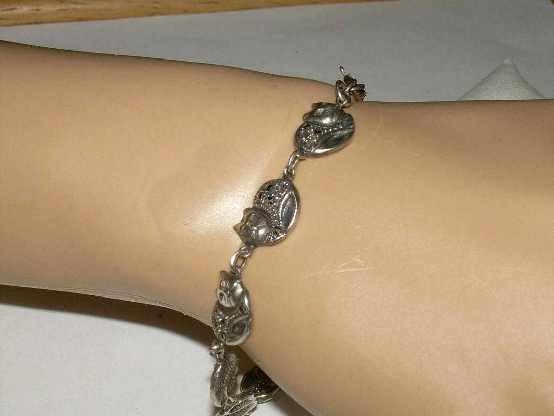 Vintage sterling Siamese Cat Bracelet - 7" , Marked: Vintage sterling silver siamese cat bracelet has 9 cat links. Each link has a siamese head along with a marcasite body. The back side of each link is marked 925. stones. The bracelet is 7" in length a