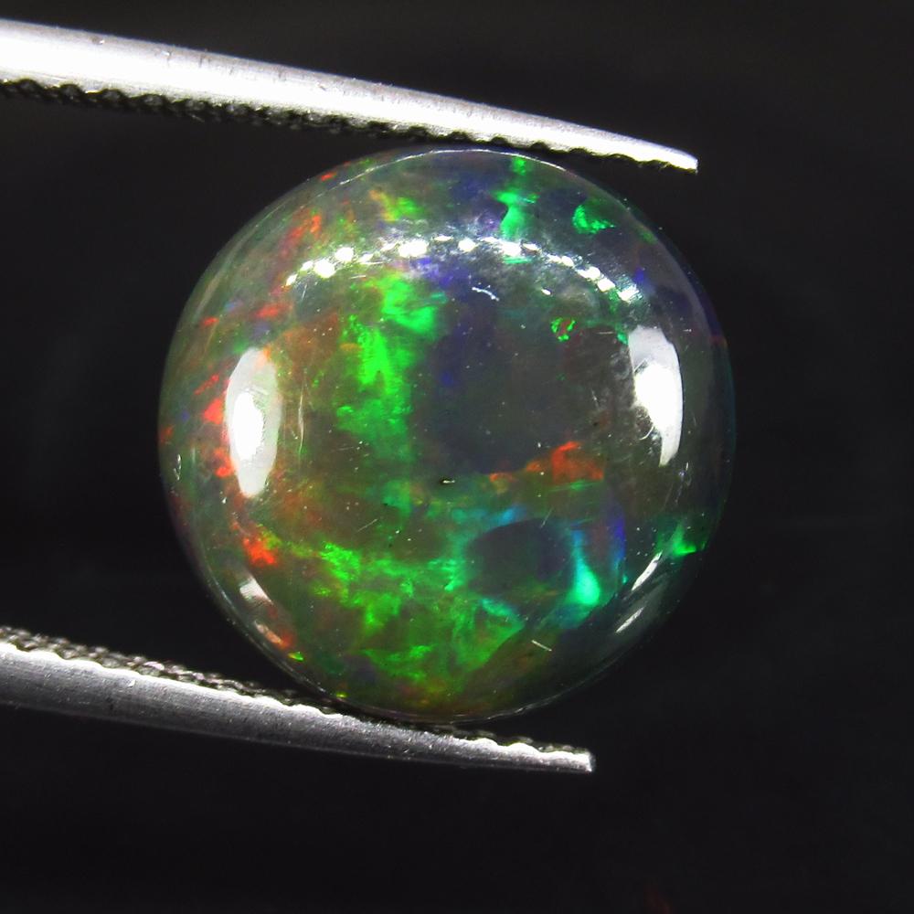 3.32 Ct Natural Ethiopian Black Fire Opal Round Cab: No Reserve! Title: 3.32 Ct Natural Ethiopian Black Fire Opal Round Cab Color/Clarity: Translucent Gemstone: Natural Black Opal Carat Weight: 3.32 Size/Dimensions: 12.30 x 12.30 x 4.00 mm Additional In