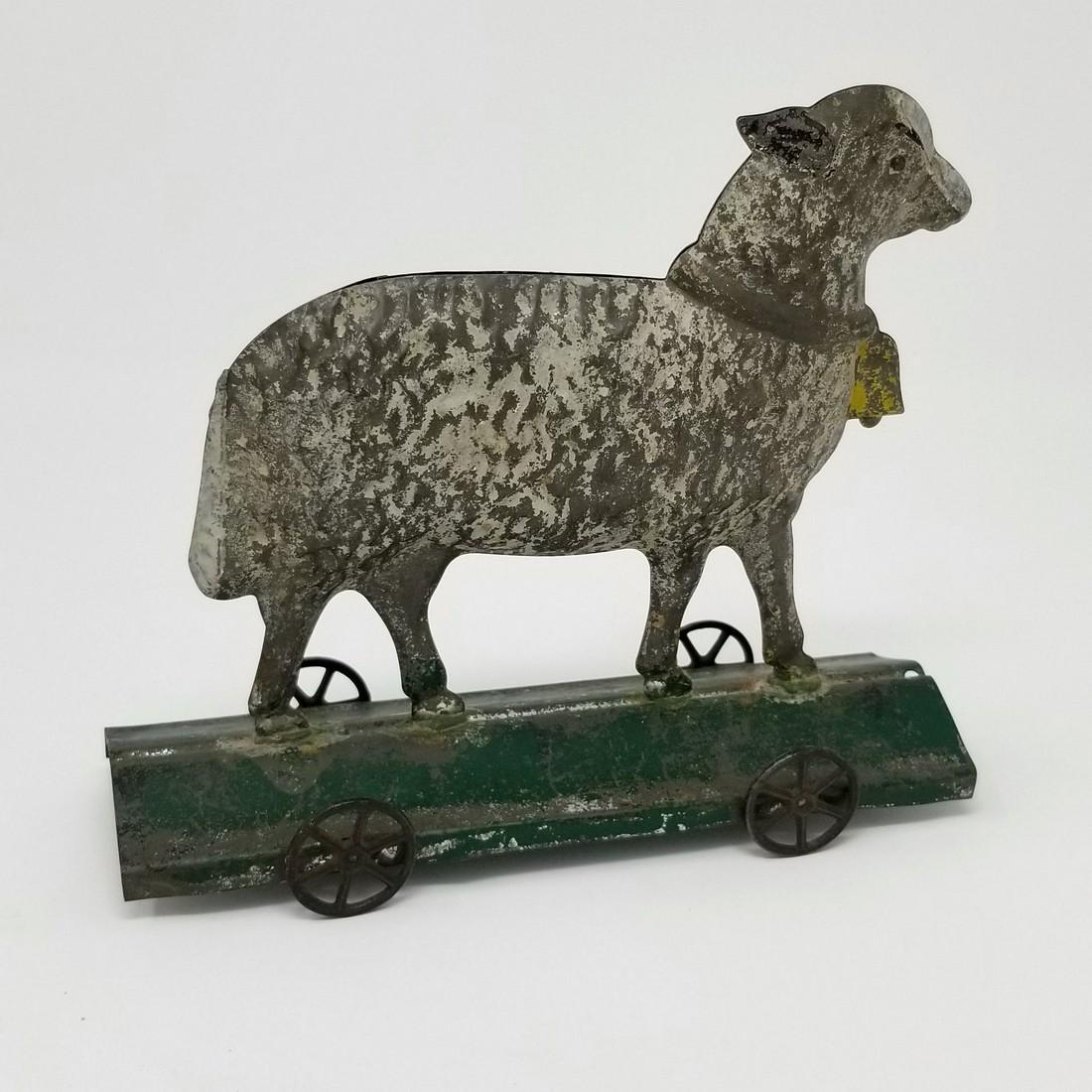 Tin sheep pull toy: Title: Tin sheep pull toy Date: 19thc Dimension: 7" L x 6 1/4"H Provenance/Additional Info: original paint and wheels Shipping: Domestic: Flat-rate of $25.00 to anywhere within the contiguous U.S. Int