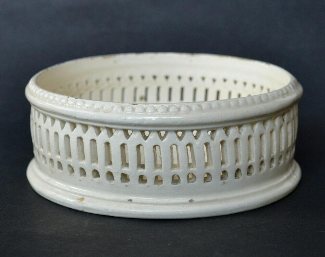 English 18th C. Creamware Wine Coaster; English 18th C.: Fine English creamware wine bottle coaster, circa late 18th Century. These were made by many of the better 18th Century creamware makers, such as Leeds or Wedgwood. This piece is unmarked. Beautifully