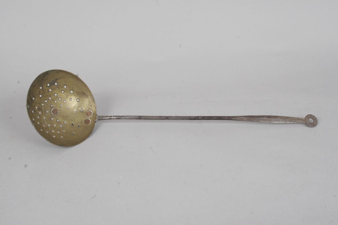 A fine late 18th century iron and brass skimmer: Title: A fine late 18th century iron and brass skimmer Date: c. 1790 Dimension: 21 1/2" L Provenance/additional info: with a chamfered handle with a doughnut terminal Shipping: Domestic: Flat-rate of 