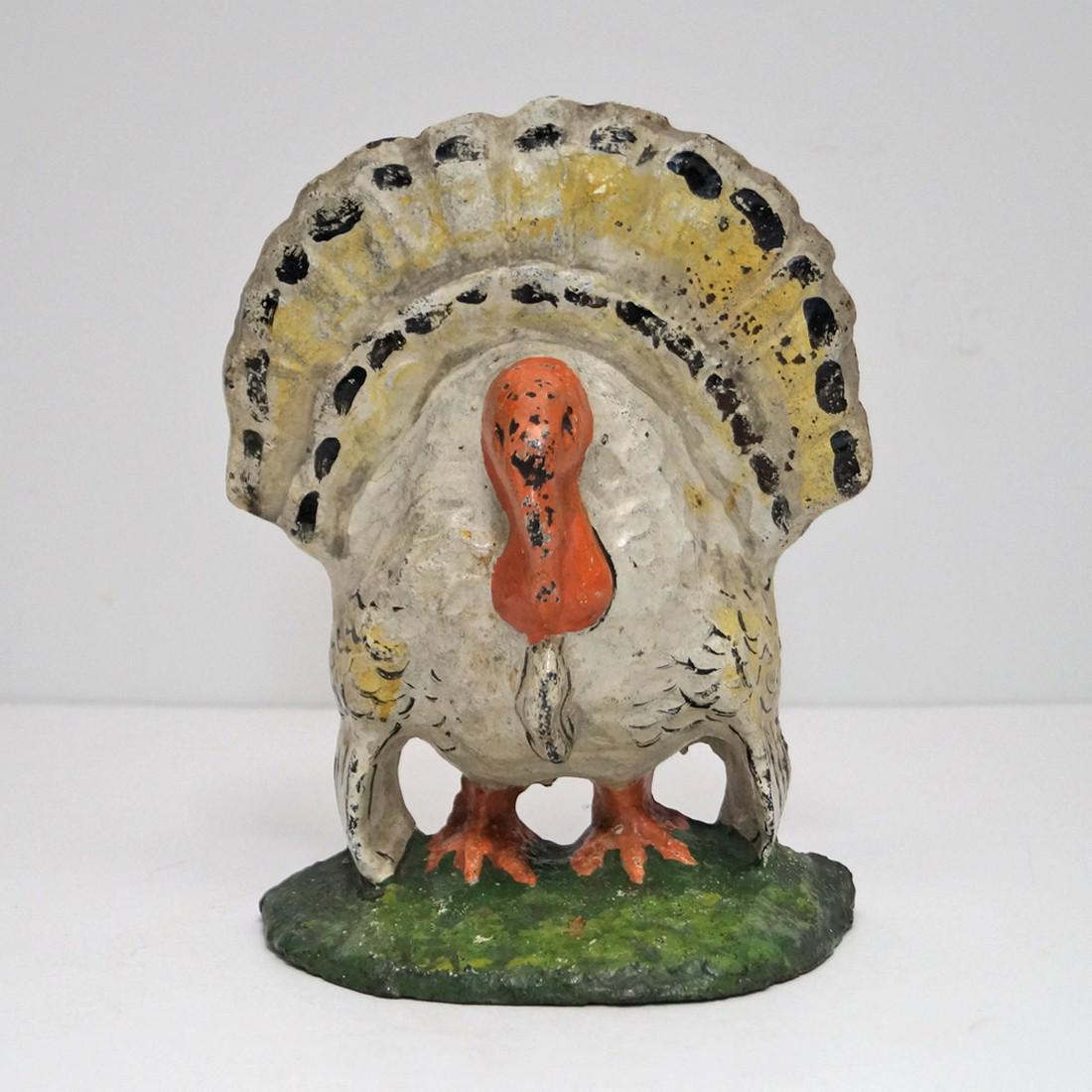 Antique Turkey Cast Iron Doorstop: Title: Antique Turkey Cast Iron Doorstop Origin: Date: Circa 1915-1920 Dimension: 6 7/8” tall x 5 ¼” wide. Provenance: Colorful depiction of Tom Turkey showing his tail fan with dropped