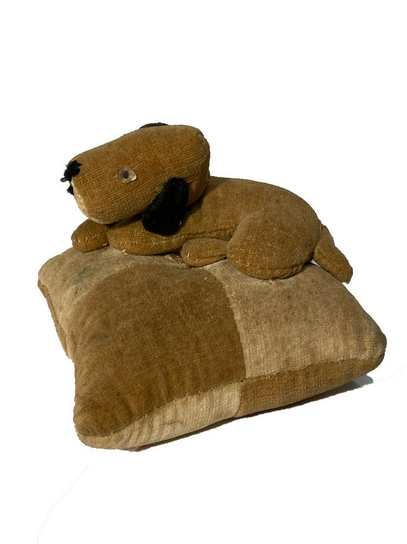 Dog Pin Cushion: Title: Dog Pin Cushion Dimensions: 4” x 4” Provenance/Additional Info: A hound with tiny button eyes seated on a pillow. Crafted with velvet. Shipping: Domestic: Flat-rate of $10.00 to anywhere wi