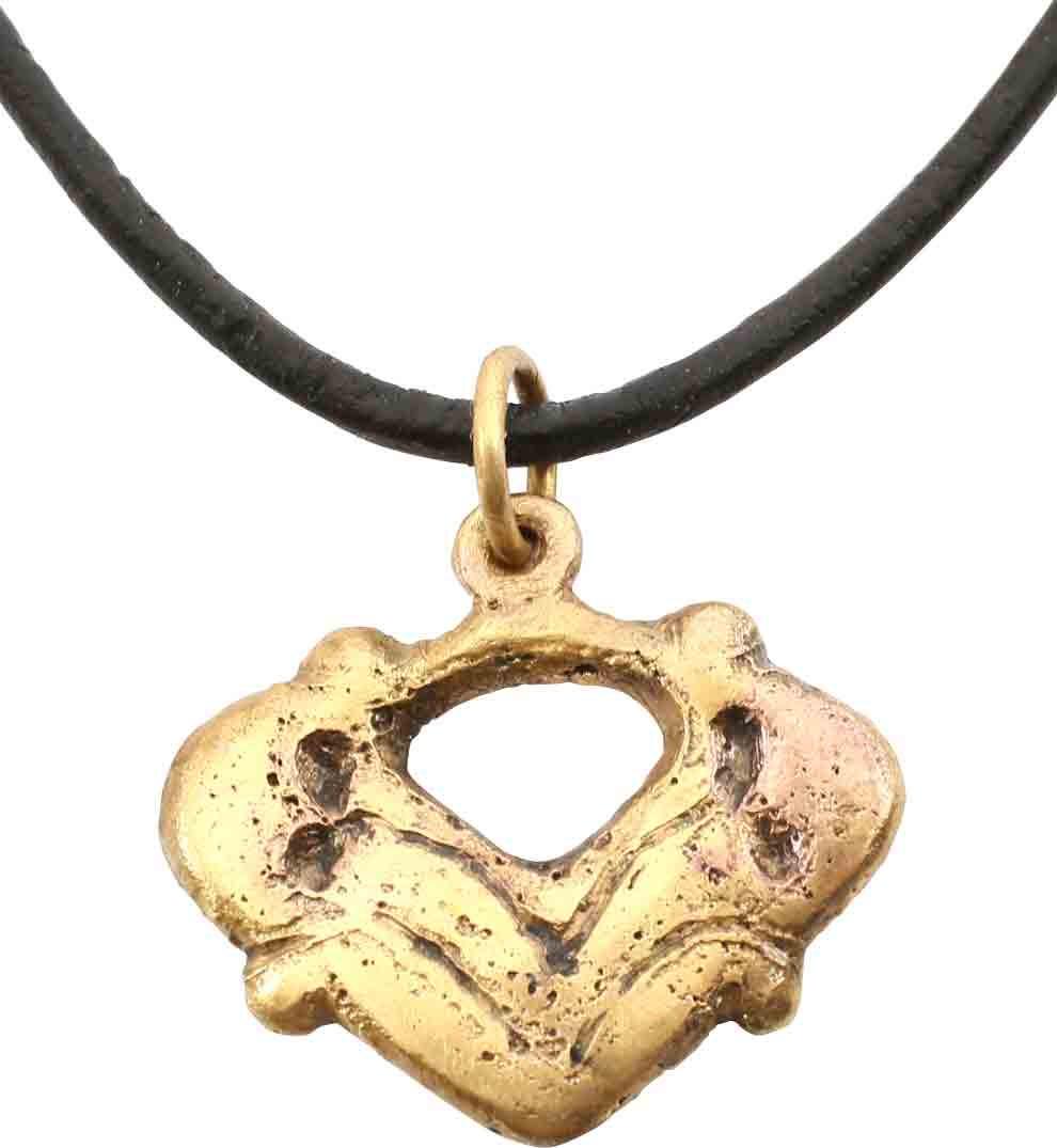 VIKING HEART PENDANT NECKLACE 900-1050 AD JEWELRY: Over 7/8” height, quarter-point nubs. Broad form with deeply cusped top stylized with a connecting bar forming a pierced heart at the top. A heart within a heart. the field with symmetrical foliate 