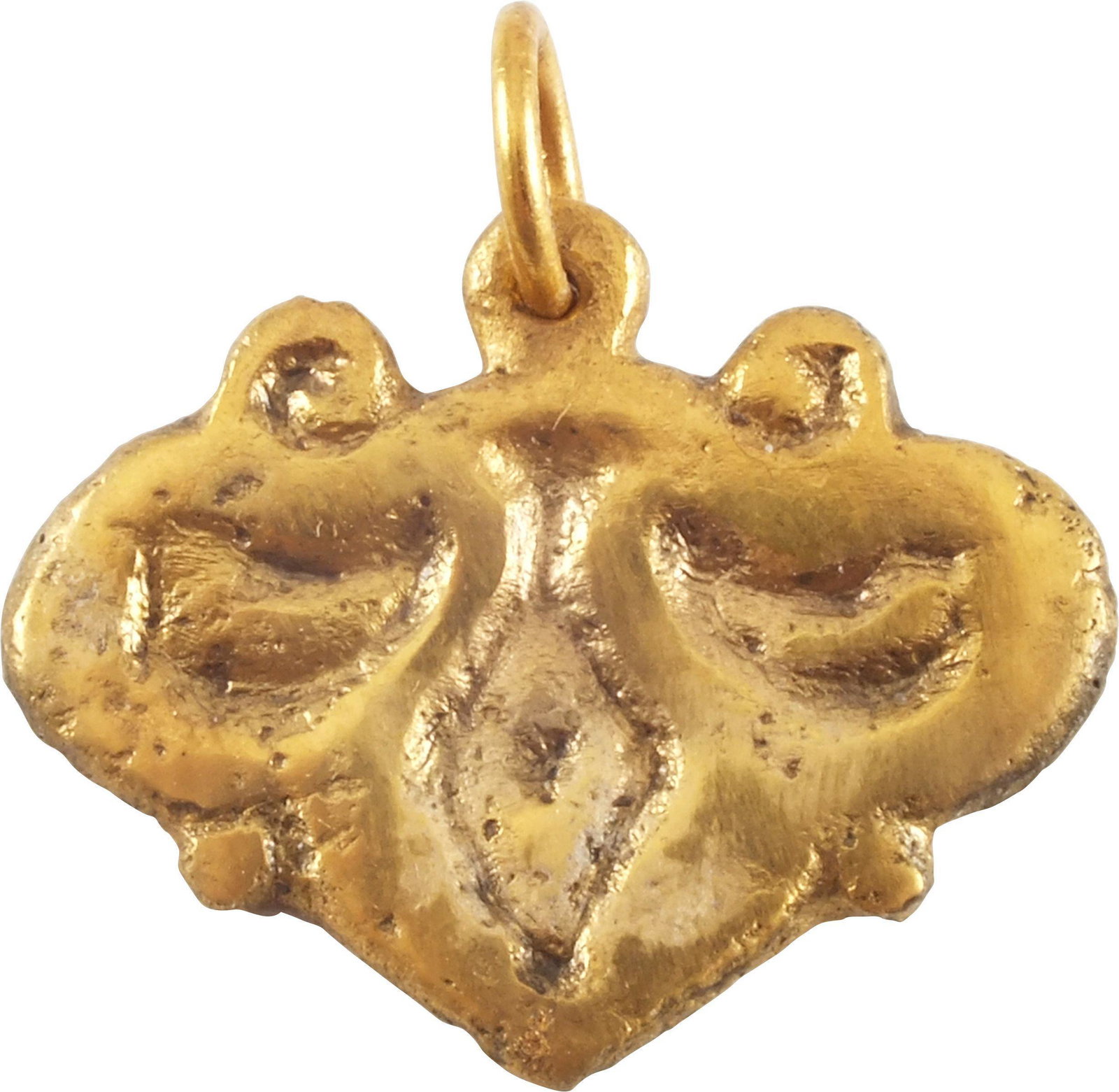 FINE VIKING HEART PENDANT 9TH-10TH CENTURY AD JEWELRY: Gilt bronze. Just under 1” width with raised edge defining the heart. The field with a well-delineated foliate trefoil in relief. The trefoil is a favorite theme for Viking decoration and is believe