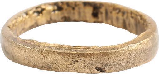 RARE VIKING BEARD RING, 10th-11th CENT AD JEWELRY: Gilt bronze. Narrowband, 2.4mm with flat sides and rounded face. Cast with a central core to distribute the metal and heat. The core than laboriously removed by hand and the remnants are visible. The 