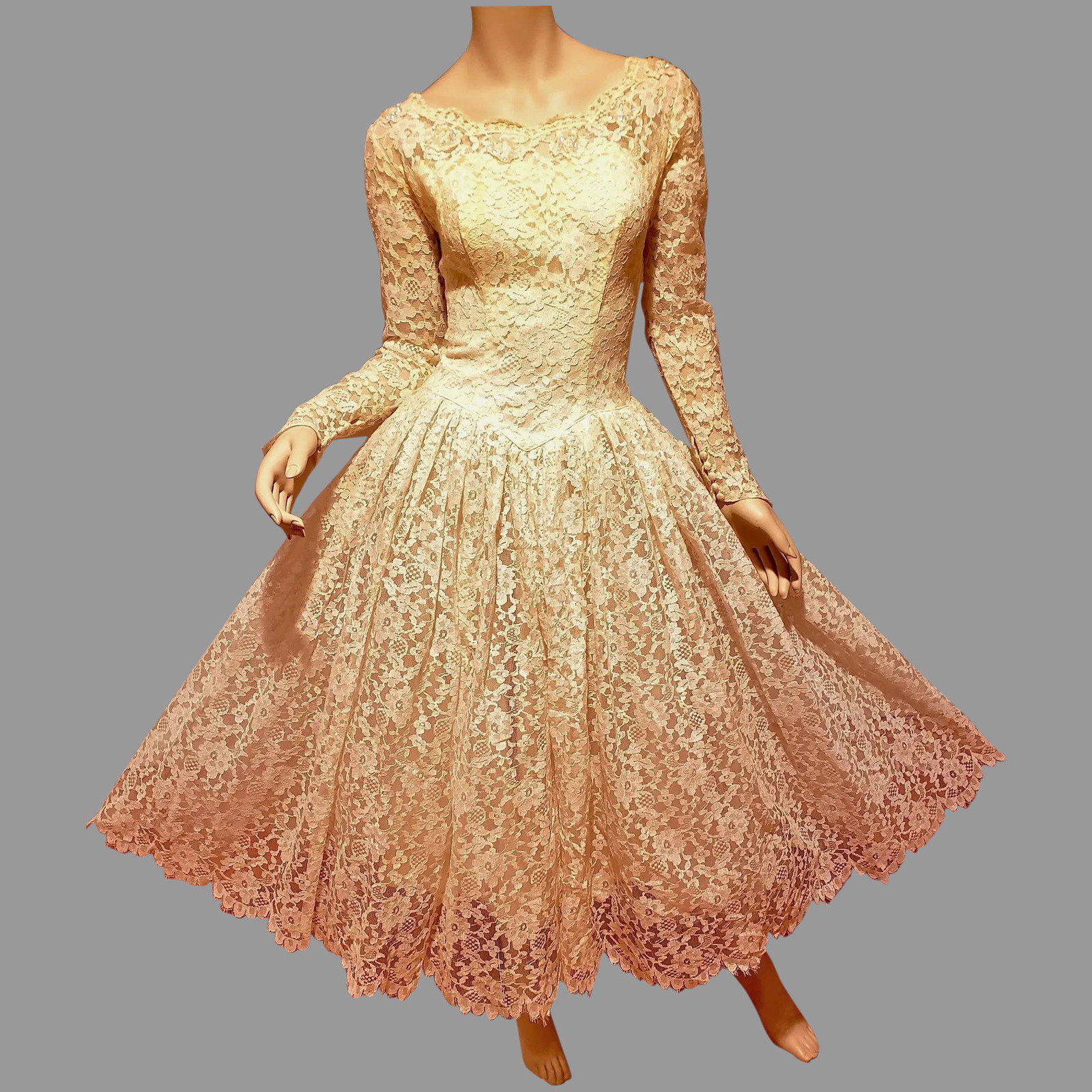 Romantic 1950's Ballerina Length French Lace bridal: Retro Romantic made of beautiful floral patterned French lace, overtop a lightweight cream colored lining, sheer sleeves and buttoned pointed cuffs, Fitted bodice with scalloped neckline dotted with s