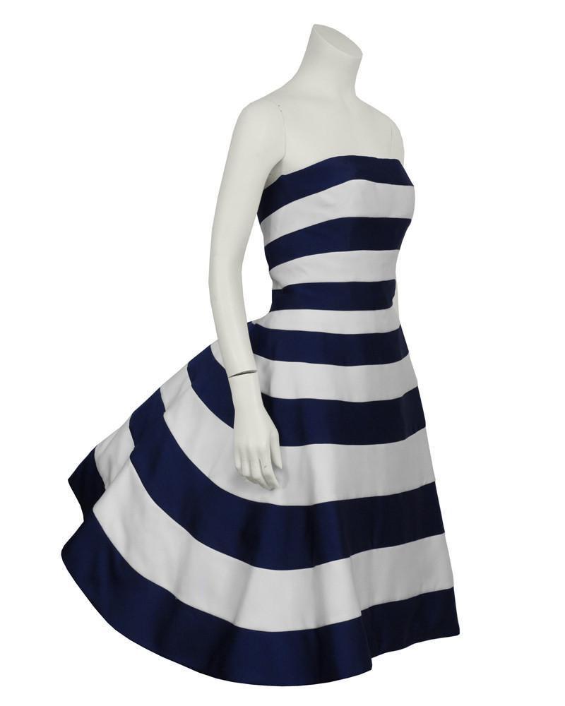 Victor Costa Navy and White Strapless Cocktail Dress: Victor Costa 1980's blue and white striped satin strapless cocktail dress. The dress is a classic Victor Costa style with a fitted front and exaggerated pouf at the back. The underskirt is cream satin