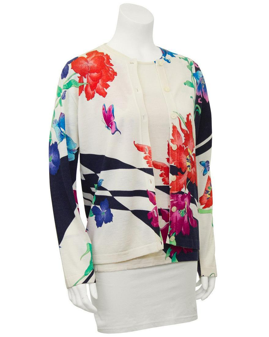 Leonard Floral Pattern Sweater Set: 1980's Leonard made-in-Paris sweater set. Fine cream color wool with bold red, yellow, black, green and blue floral design with butterflies. Short sleeve T-shirt style inner sweater with matching butt