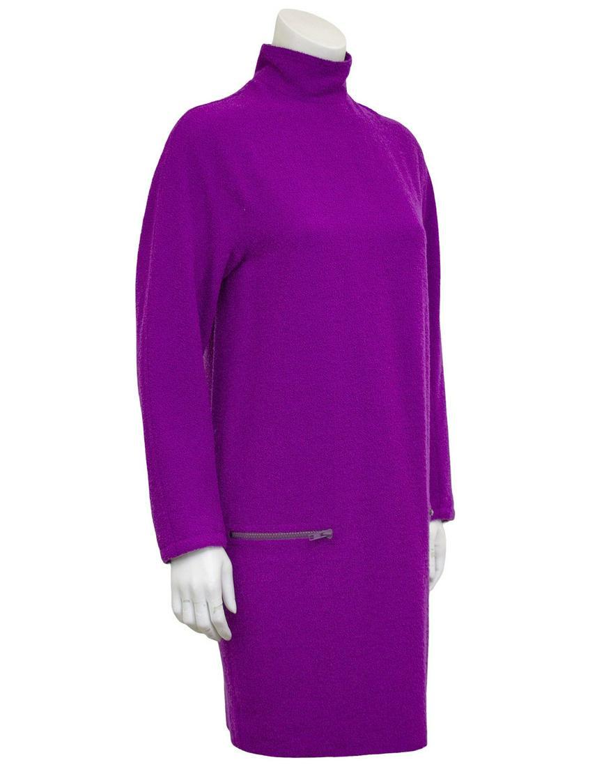 Versace Purple Boiled Wool Tunic Dress: 1980s Gianni Versace vibrant purple/fushia tunic dress. Textured, boiled wool with long sleeves and turtleneck. Straight horizontal zipper pockets. Chic worn alone with boots or over pants. Excellent