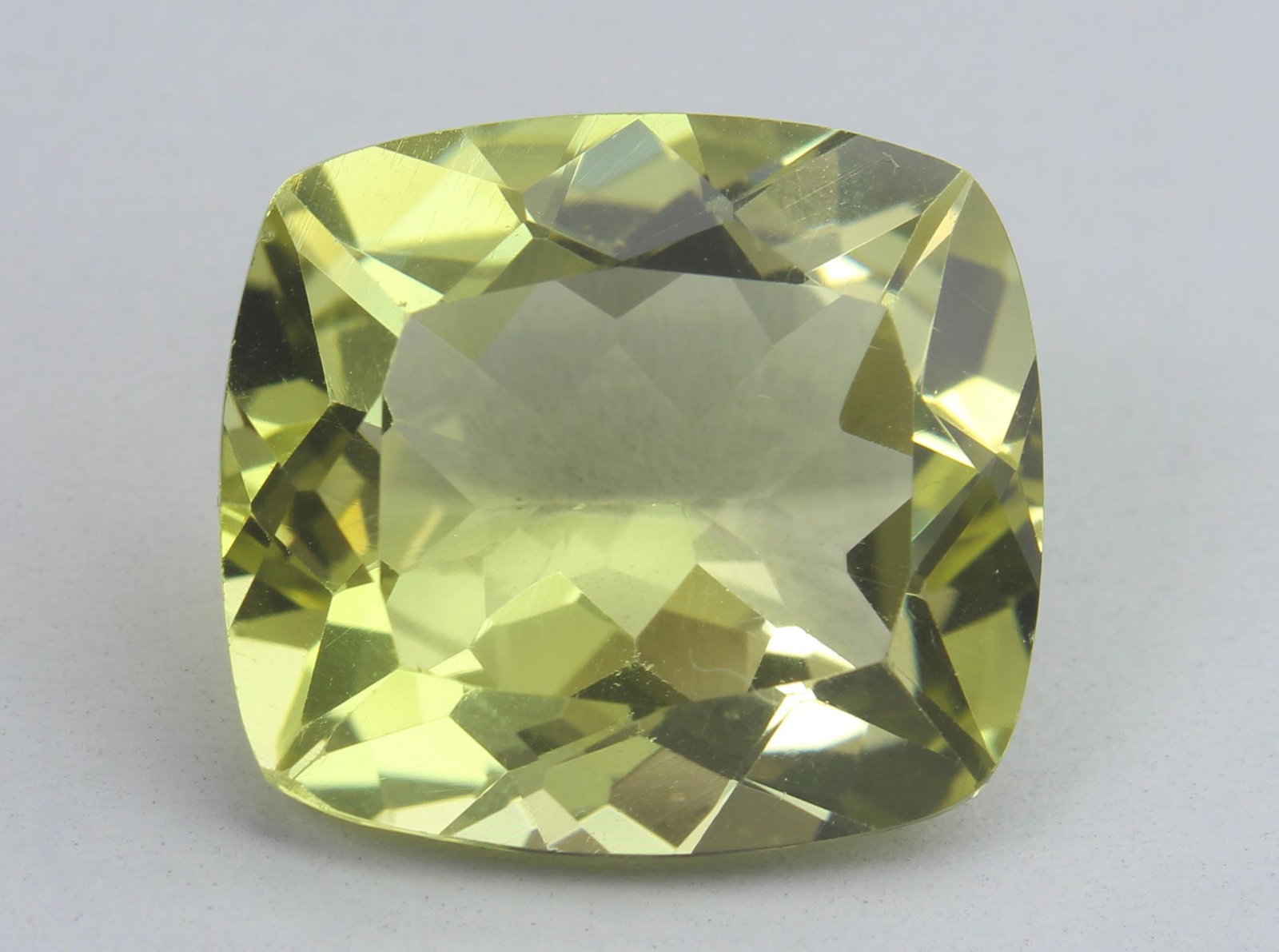 13.06 Ct Natural Lemon Quartz: No Reserve! Title: 13.06 Ct Natural Lemon Quartz Additional Info: Gemstone : Lemon QuartzWeight : 13.06 CtsShape : Rectangular Cushion CutColour : Greenish YellowDimensions : 16.2x14.6x8.9 mmOrigin : 