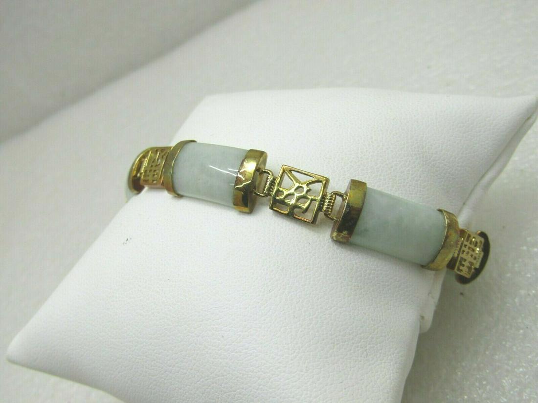 Gold Tone Jadeite Asian Symbol Bracelet, 7.5", 9 mm: Jadelite Asian Symbol Bracelet, Gold Tone, 7.5", 9mm wide. Signed R and China. Each of the mint green jadeite links - and there are six) are domed on top and appx. 3mm thick, are capped with a bezel o