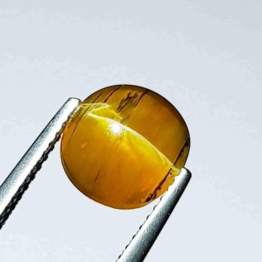 3.09 ct Natural Opal Cat's Eye: No Reserve! Title: 3.09 ct Natural Opal Cat's Eye Color/Clarity: Semi Transparent Carat Weight: 3.09 Dimensions: 9.40 x 8.85 x 6.45 Additional Information: Round - Africa Shipping: Domestic: Flat-rat