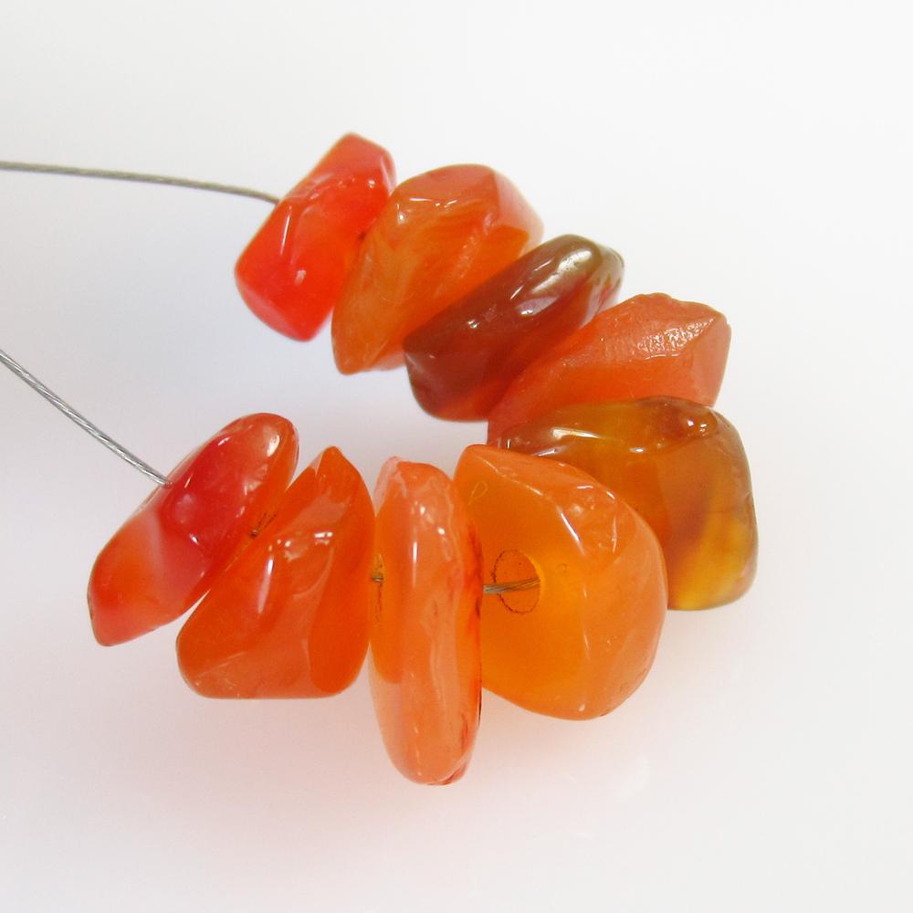 17.95 Ct Natural 9 Drilled Carnelian Unshaped Beads: No Reserve! Title: 17.95 Ct Natural 9 Drilled Carnelian Unshaped Beads Stone Clarity: Semi-Transparent Gemstone: Natural Carnelian Beads Carat Weight: 17.95 Size/Dimensions: 7.7x4.0 - 9.6x3.5 mm / 9 P