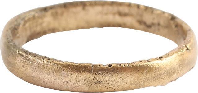 ANCIENT VIKING WEDDING RING SIZE 3 ½: Late 9th-early 11th century AD. Gilt bronze, size 3 1/2. Medium width band 2.8mm, with a rounded face. The inside with distinct tool marks from the removal of the central core after casting. Professio