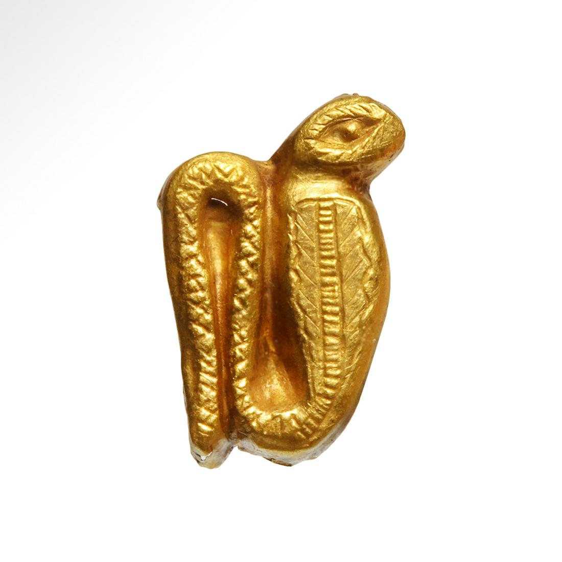Egyptian Gold Plaque of the Uraeus Cobra: Title: Egyptian Gold Plaque of the Uraeus Cobra Date & Origin: Egypt c. 600 B.C. Description: Coiled cobra of sheet gold, repousse work with finely incised frontal details and decorations. Dimension: 