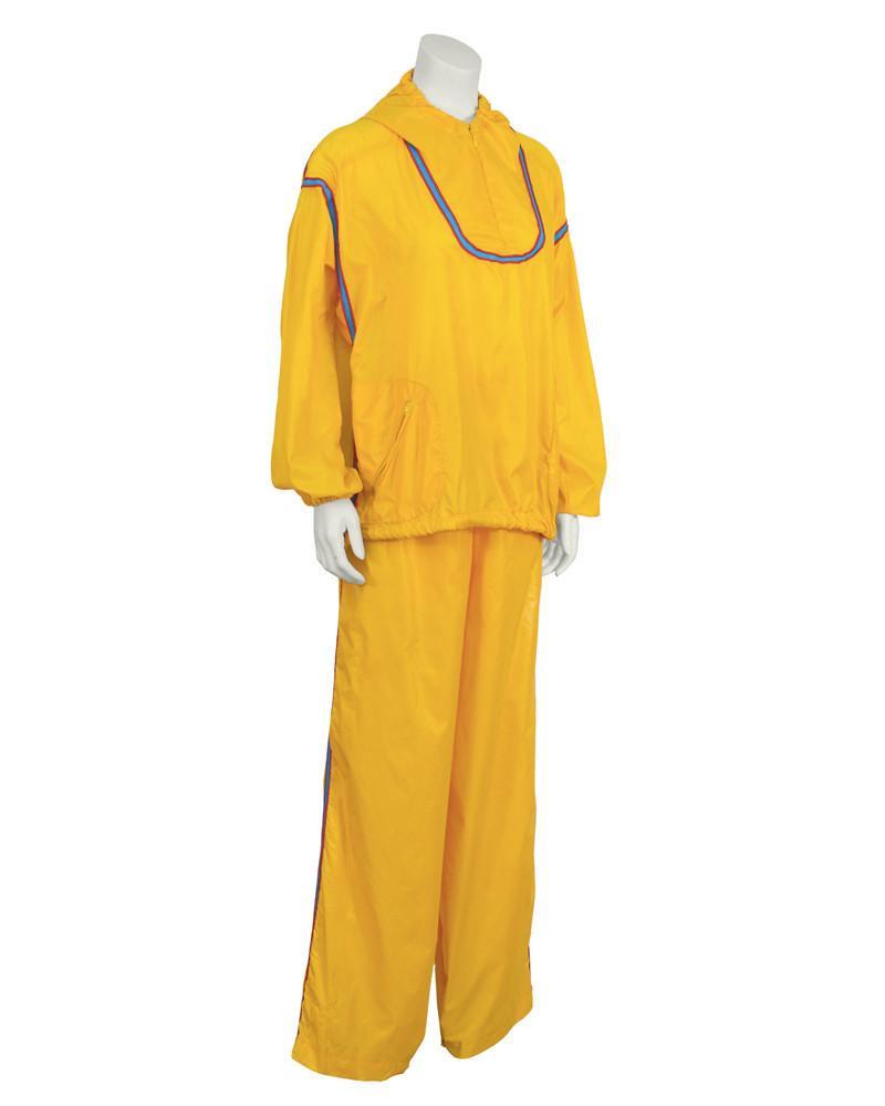 Geoffery Beene Yellow Windbreaker Outfit: The Beene Bag by Geoffrey Beene canary yellow wind suit warm up outfit from the 1970's.. The zip neck jacket features diagonal zip pockets, and elasticized cuffs. The jacket can be tightened with the 
