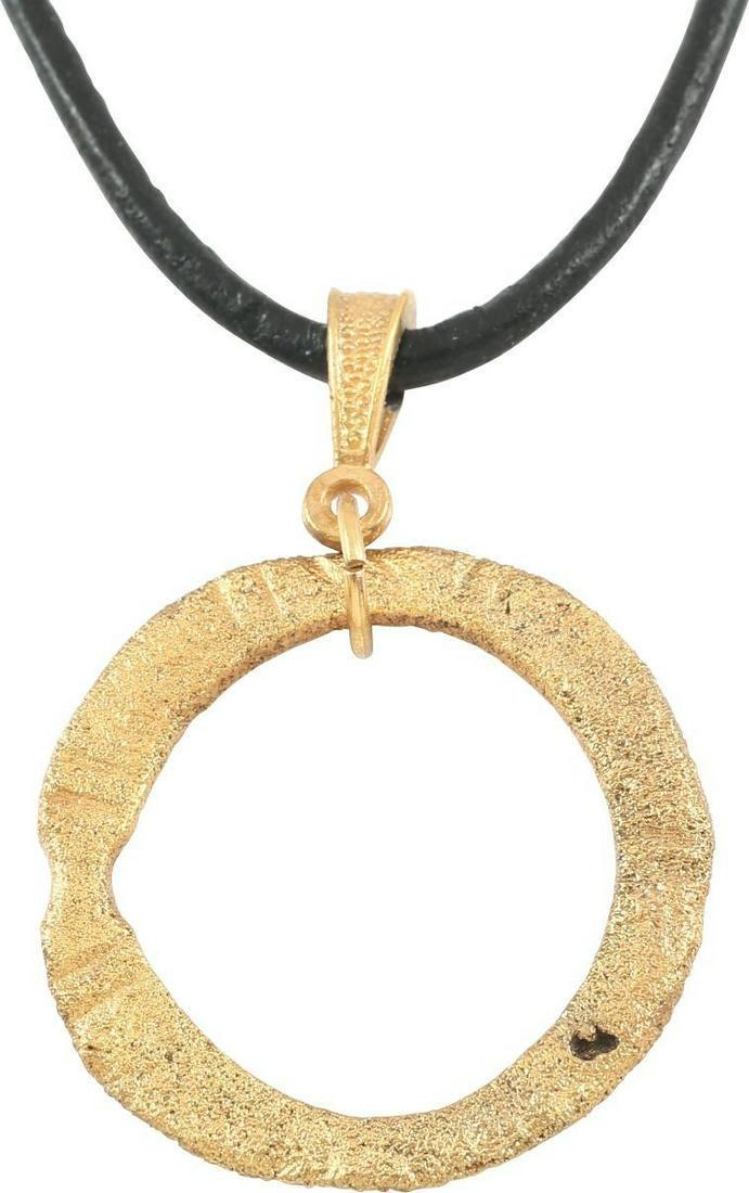 VIKING PROTECTIVE BROOCH NECKLACE, 10th-11th CENTURY: Bronze, just under 1” diameter. Flat faces both sides. The front with incised radial lines. Textured from burial. Worn in numbers, these were decorative as well as serving as a measure of protection